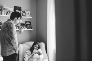 in home newborn photography by Angie Menos - mom and dad with baby