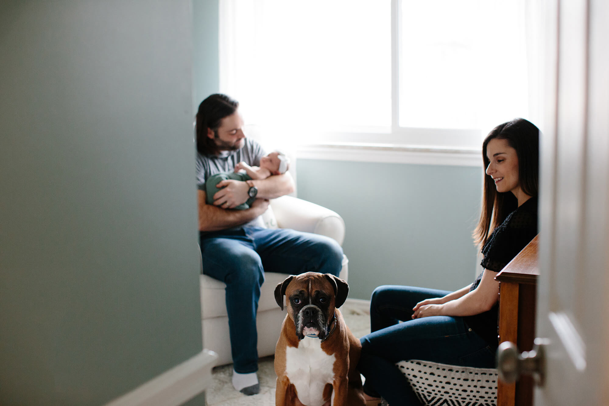 in home newborn photography by Angie Menos - mom, dad and dog with new baby at home